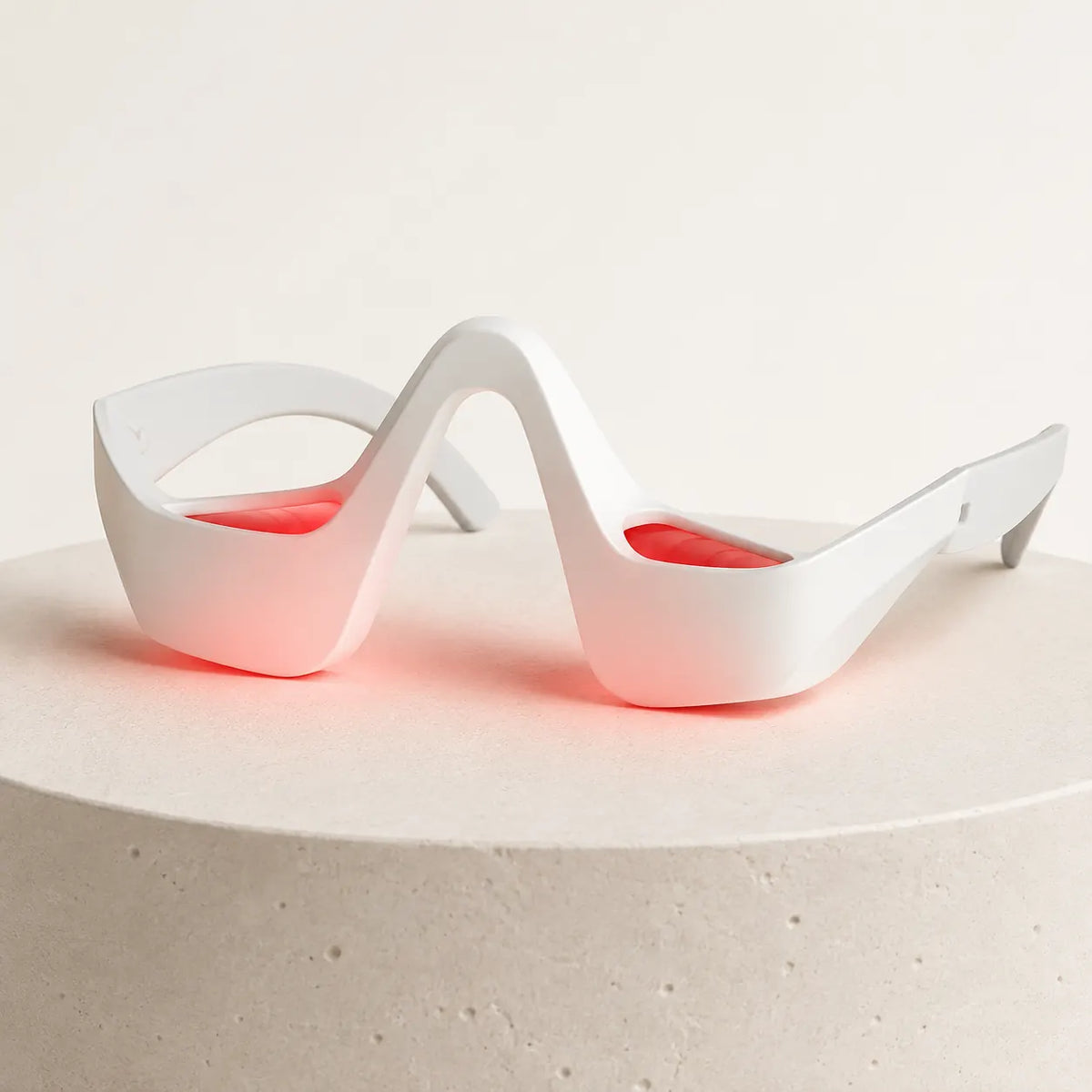 Red Light Under-Eye Therapy Glasses on a clean studio background